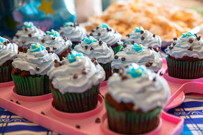 Colorful cupcakes ready to eat and served on a pink tray, homemade pastry