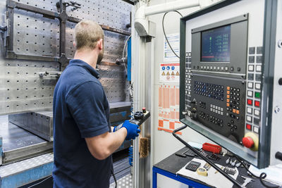 Man operating machine in industrial factory