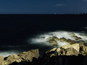 Scenic view of sea and rocks against sky