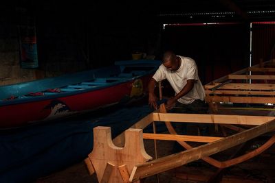 Full length of man standing on boat at night