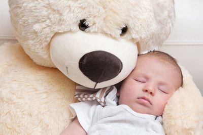 High angle view of baby sleeping in toy