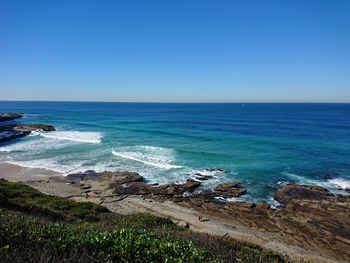 Scenic view of sea against clear blue sky