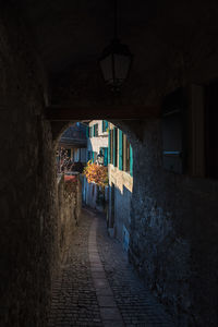 Empty alley amidst buildings in city