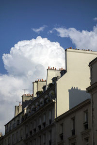 Low angle view of building against cloudy sky