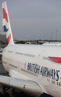 Close-up of airplane on airport runway against sky