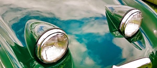 High angle view of reflection of car on side-view mirror