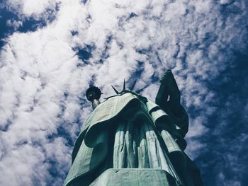 Low angle view of statue against cloudy sky