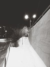 Illuminated snow covered road at night