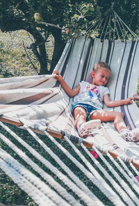 Full length of girl on hammock in plants