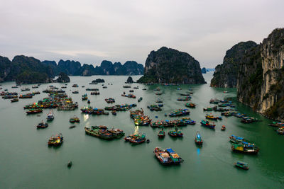 High angle view of boats moored in sea against sky