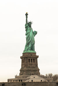 Low angle view of statue of liberty against sky