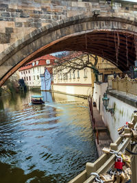 Arch bridge over canal amidst buildings