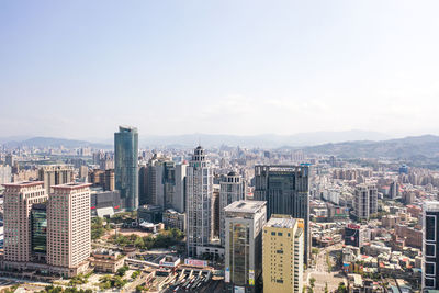 High angle view of modern buildings in city against sky