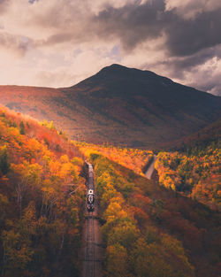 Scenic view of scenic railroad and mountains against sky during autumn