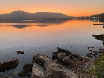 Scenic view of lake against sky during sunset