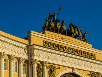 Low angle view of statue against blue sky