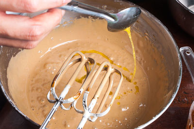 Cropped hand preparing food in bowl