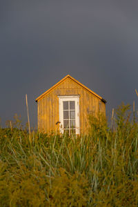 House on field against sky