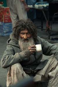 View of mature man drinking tea outdoors