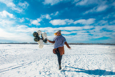 Rear view of woman on snow covered land