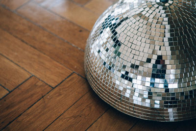 High angle view of shining disco decoration on hardwood floor