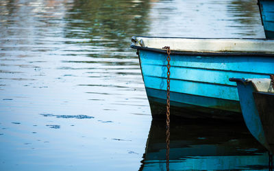 Boat moored on pier over lake