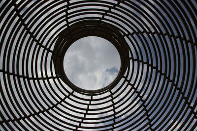 Low angle view of skylight in building against sky