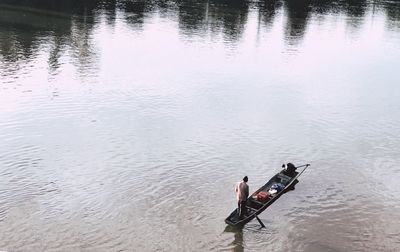 High angle view of man sitting in lake