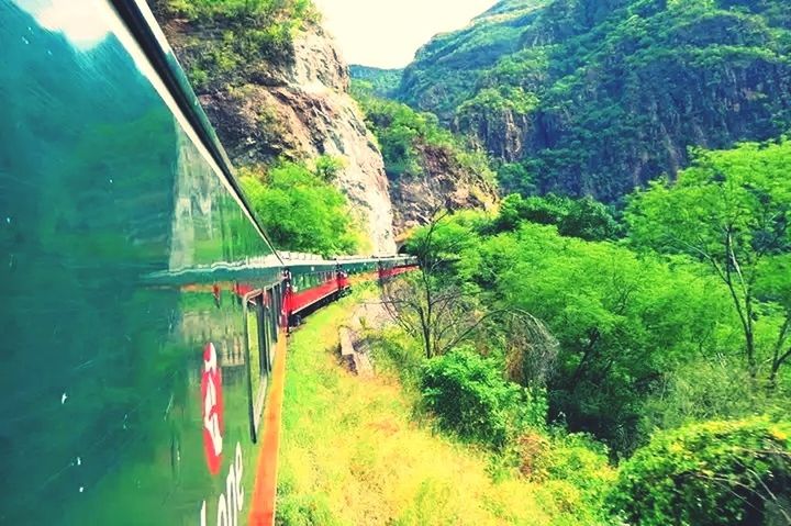 mountain, water, transportation, green color, tree, tranquility, scenics, beauty in nature, tranquil scene, nature, bridge - man made structure, connection, mountain range, river, travel, tourism, day, non-urban scene, lush foliage, idyllic