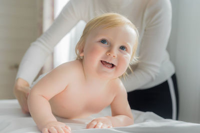 Mom gives her baby a shoulder and back massage. close-up.