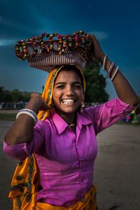 Portrait of smiling woman standing on beach