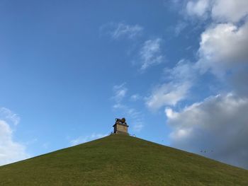 Low angle view of cross on beach against sky