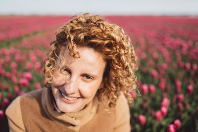 Portrait of woman in a pink tulip field