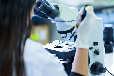 Rear view of woman working in laboratory