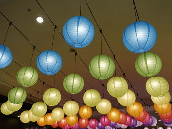 Low angle view of illuminated lanterns hanging on ceiling