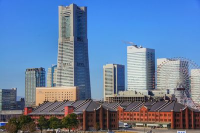 Low angle view of buildings against clear blue sky