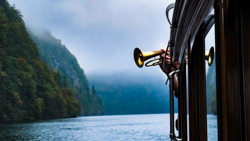 Autumn lake cruise where trumpet is played to demonstrate echoes... konigsee, germany.