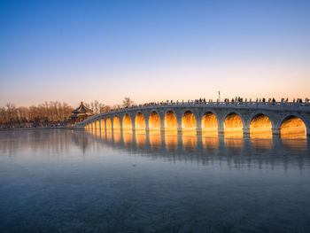 Bridge over river against clear sky