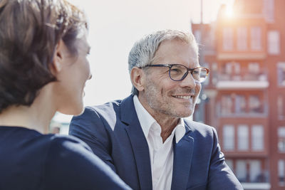 Confident businessman and businesswoman outdoors