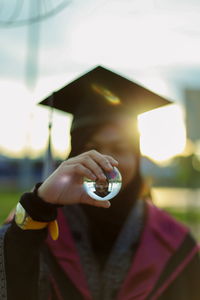 Midsection of woman holding umbrella