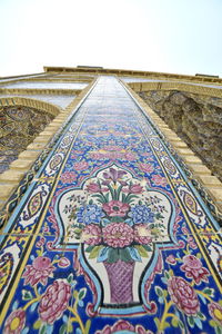 Close-up of multi colored wall of building against sky