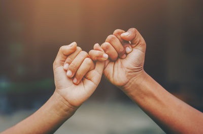 Cropped hands doing pinky promise