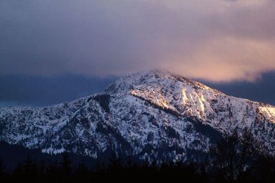 Scenic view of mountains against cloudy sky