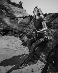 Portrait of woman sitting on rock