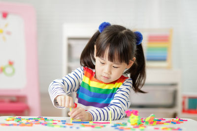 Full length of cute girl playing with toy