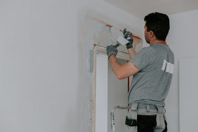 Side view of young man photographing through camera