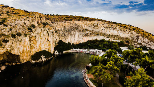 Scenic view of river amidst mountains against sky