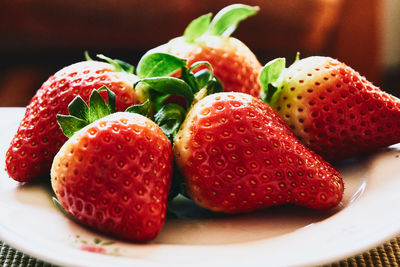 Close-up of strawberries in plate on table