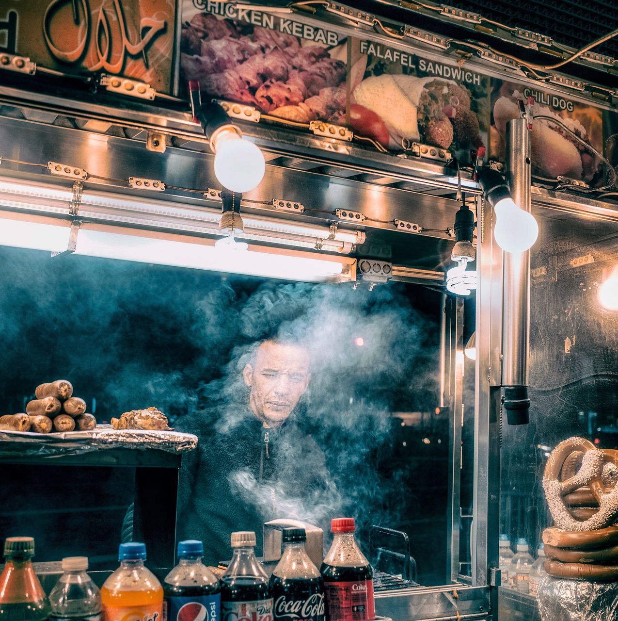 smoke - physical structure, indoors, food and drink, glass - material, one person, restaurant, container, food, illuminated, store, jar, transparent, real people, business, shelf, large group of objects, men, household equipment, motion