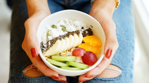 High angle view of person holding fruit salad